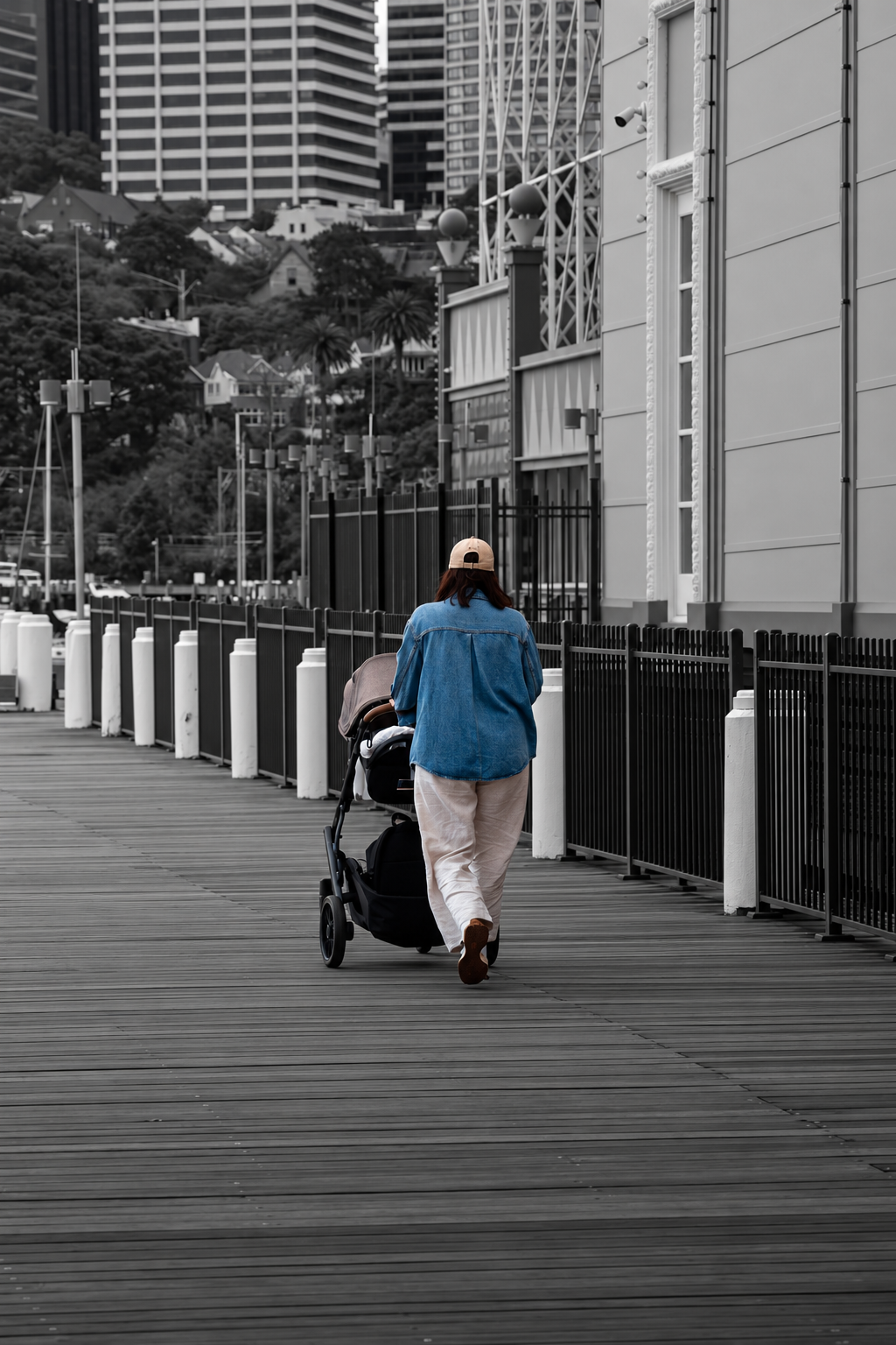 Person walking with a stroller along a waterfront